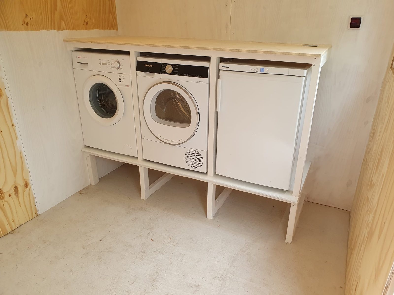 Utility room after, with the washing machine, dryer and freezer fitted