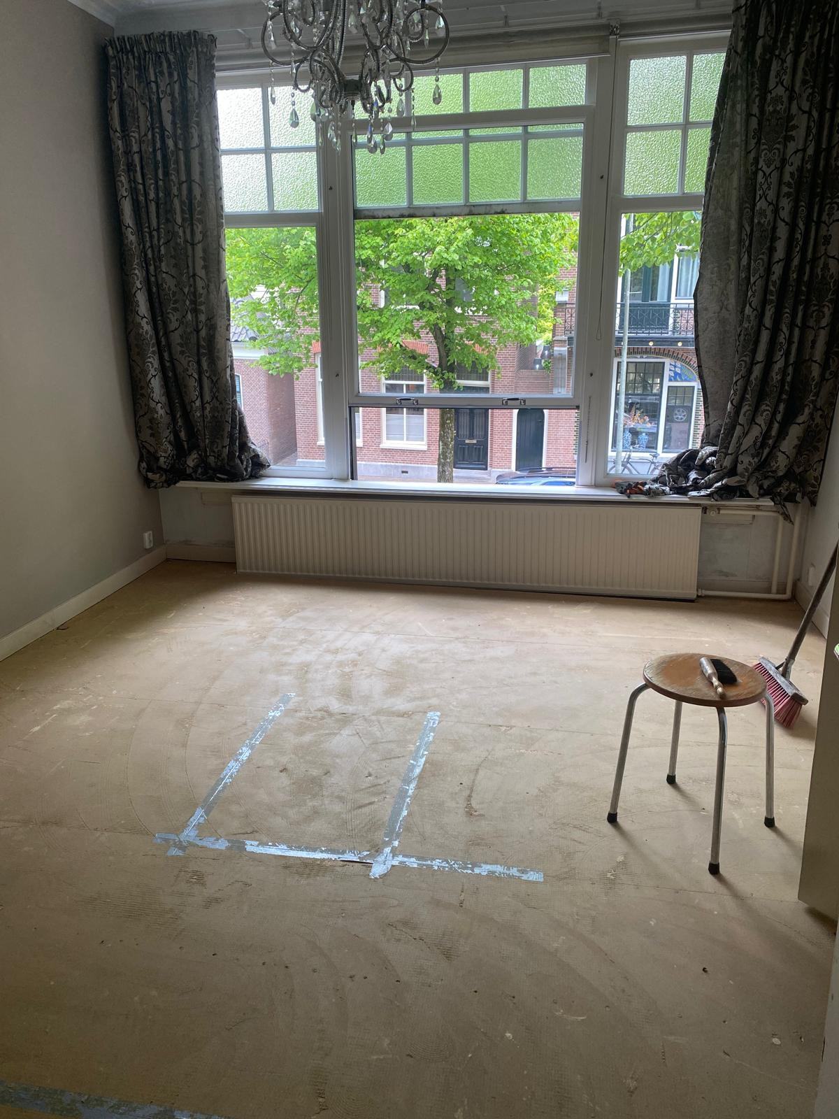 Bedroom before, carpet removed and the subfloor marked out