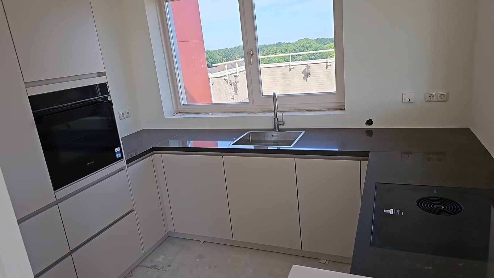 Kitchen after, with new cabinets, worktop and sink