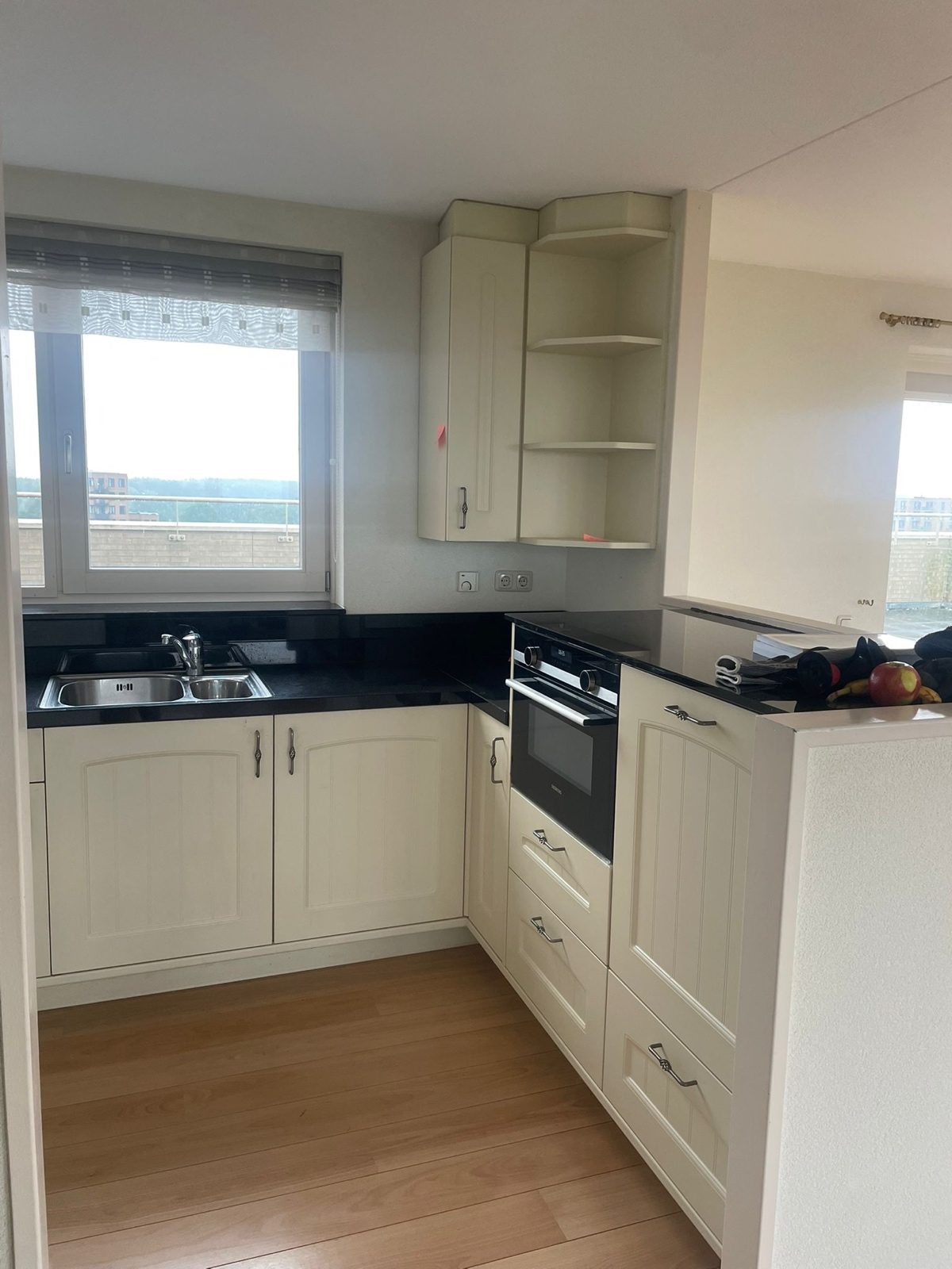Kitchen before, with the old cream cabinets
