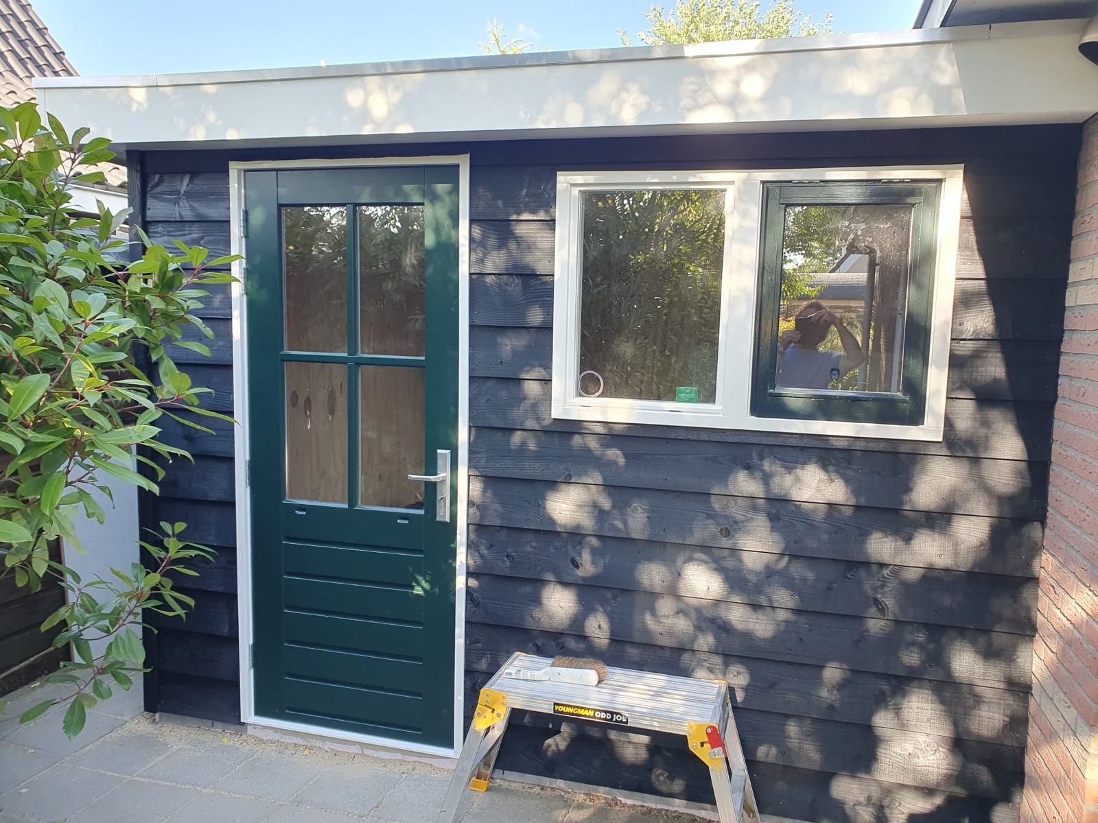 Finished garden room with cladding, door and windows